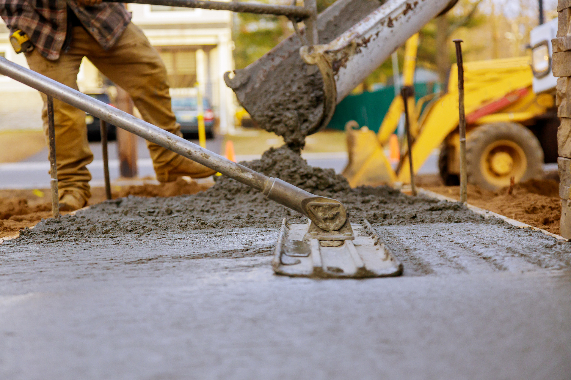Concrete crew pouring and finishing a fresh concrete slab